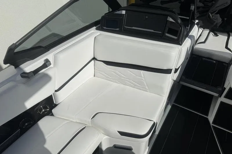 Slide: The Image of 2025 Supra SL 575 boat interior with white leather seating and black accents. - 9