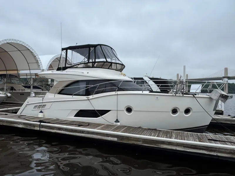 The Image of 2014 Carver C40 Command Bridge yacht docked at marina under cloudy sky. - 0