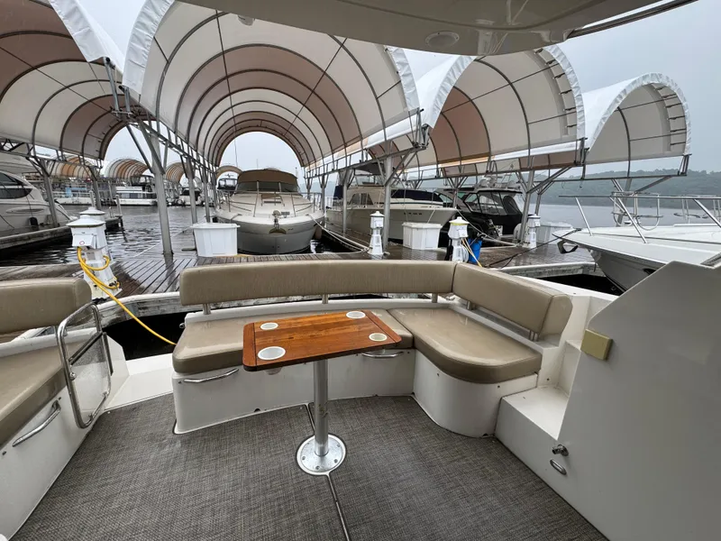 Slide: The Image of 2014 Carver C40 Command Bridge yacht with seating area, docked under covered marina. - 11