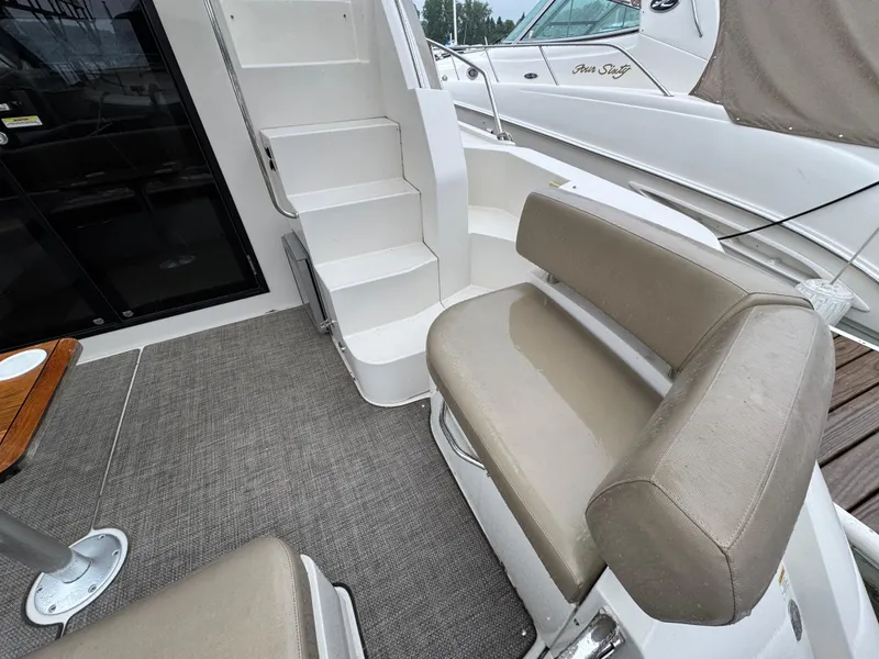 Slide: The Image of 2014 Carver C40 Command Bridge interior with seating and stairs, featuring beige upholstery. - 12