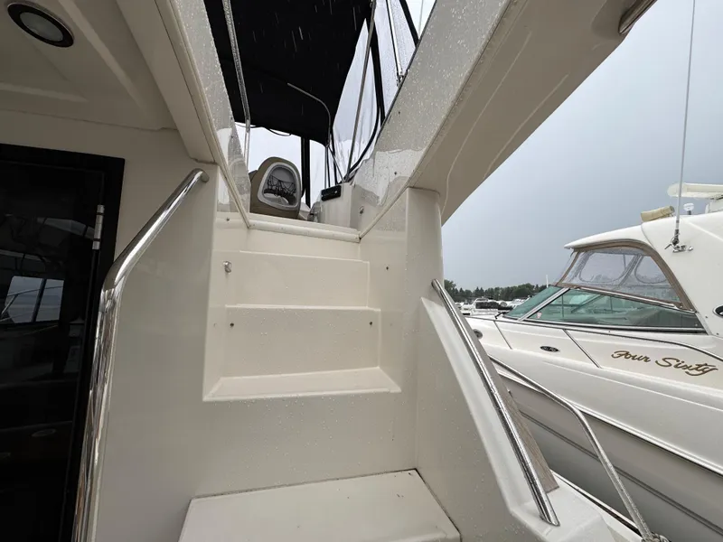 Slide: The Image of Staircase leading to upper deck of 2014 Carver C40 Command Bridge yacht. - 14