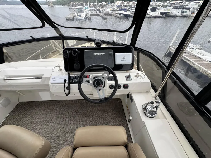 Slide: The Image of 2014 Carver C40 Command Bridge helm with Raymarine navigation, docked at marina. - 17