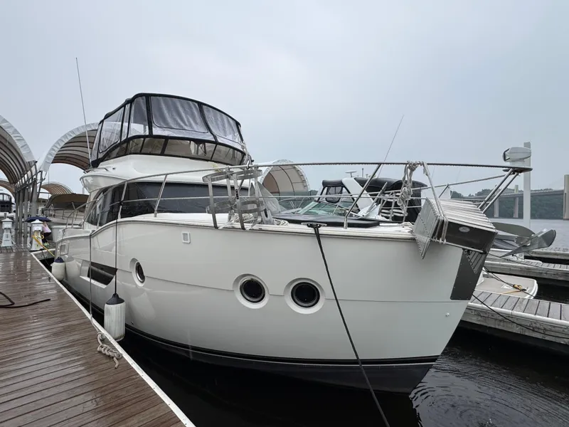 Slide: The Image of 2014 Carver C40 Command Bridge yacht docked at a marina. - 2