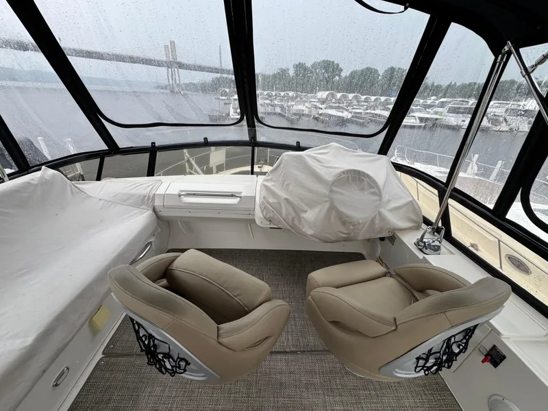 Slide: The Image of 2014 Carver C40 Command Bridge interior with beige seating and panoramic windows. - 20