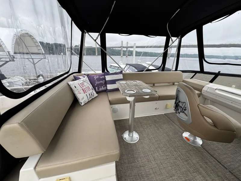 Slide: The Image of 2014 Carver C40 Command Bridge interior with seating, table, and lake view. - 22