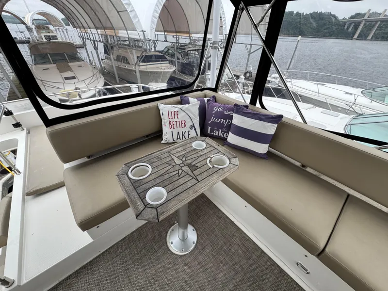 Slide: The Image of Interior of 2014 Carver C40 Command Bridge with cozy seating and decorative pillows. - 23