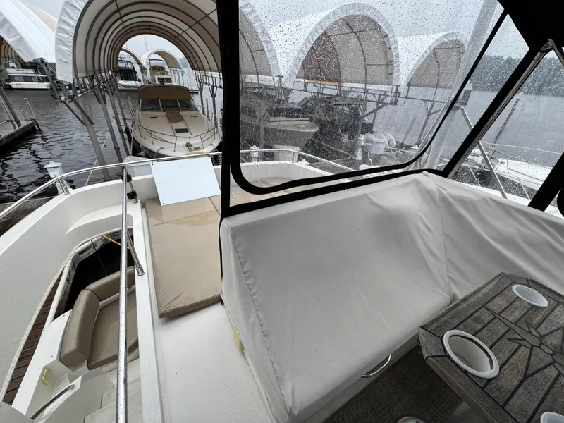 Slide: The Image of 2014 Carver C40 Command Bridge yacht docked under covered marina. - 24