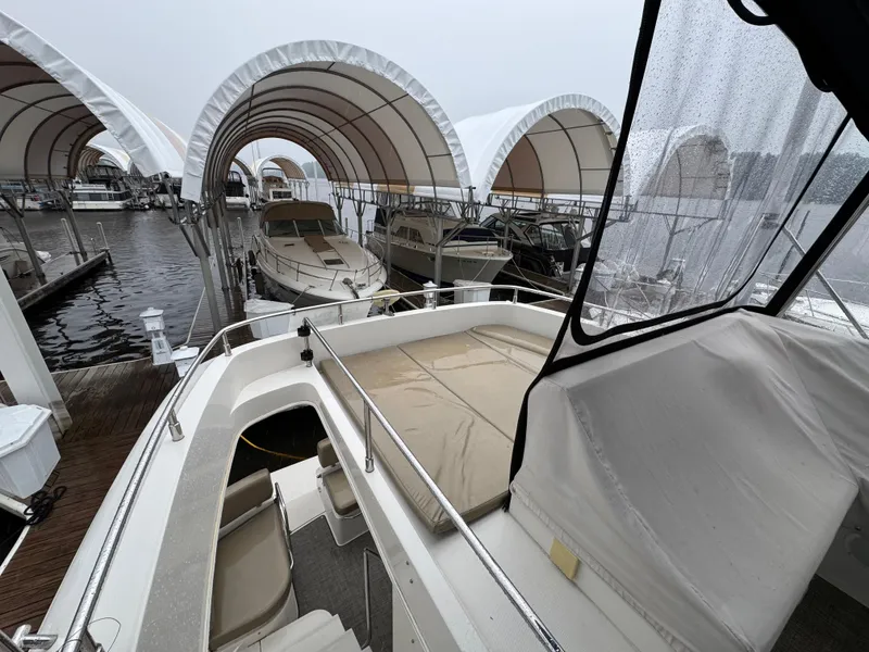 Slide: The Image of 2014 Carver C40 Command Bridge yacht docked under covered marina. - 25
