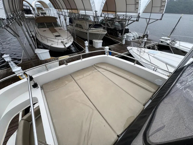 Slide: The Image of 2014 Carver C40 Command Bridge docked among other boats under canopy. - 26