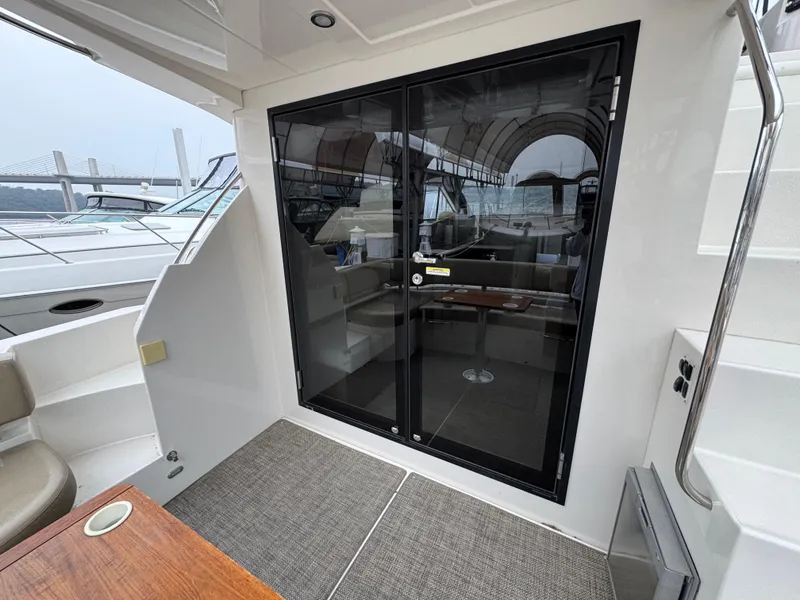 Slide: The Image of 2014 Carver C40 Command Bridge yacht interior with glass doors and seating area. - 27