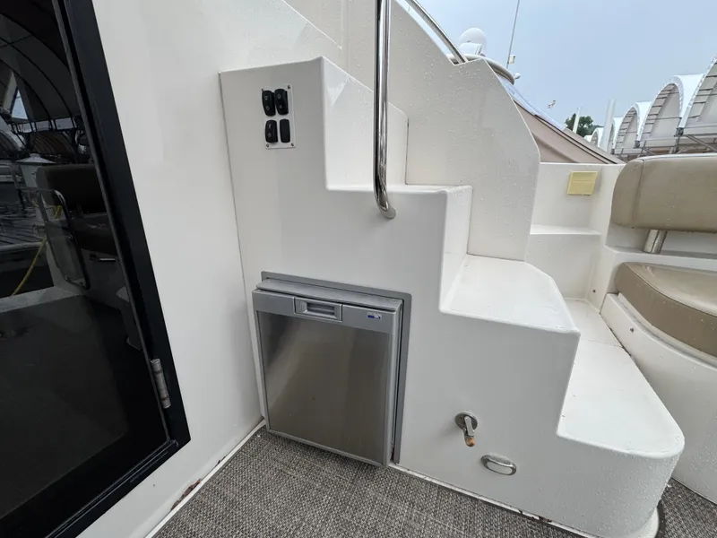 Slide: The Image of 2014 Carver C40 Command Bridge interior with stairs and built-in mini fridge. - 28