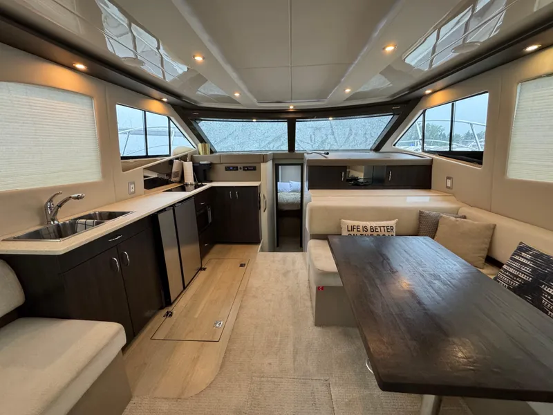 Slide: The Image of Luxurious interior of 2014 Carver C40 Command Bridge yacht with modern kitchen and seating area. - 31