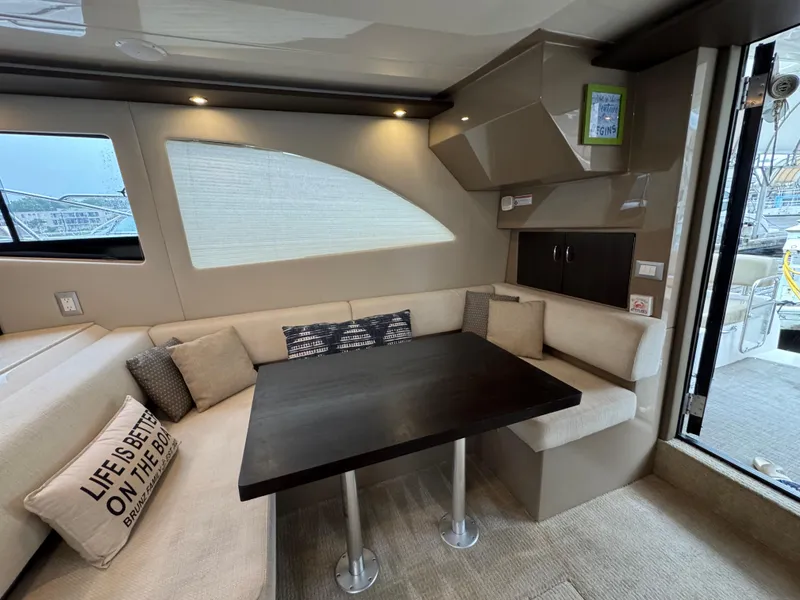 Slide: The Image of Interior of 2014 Carver C40 Command Bridge yacht with cozy seating and dining area. - 32