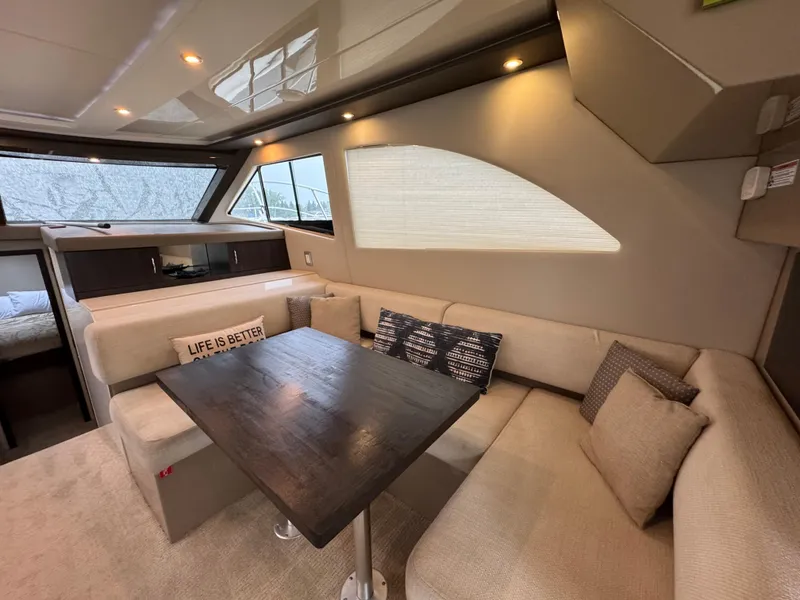 Slide: The Image of Luxurious interior of 2014 Carver C40 Command Bridge yacht with cozy seating and dining area. - 33