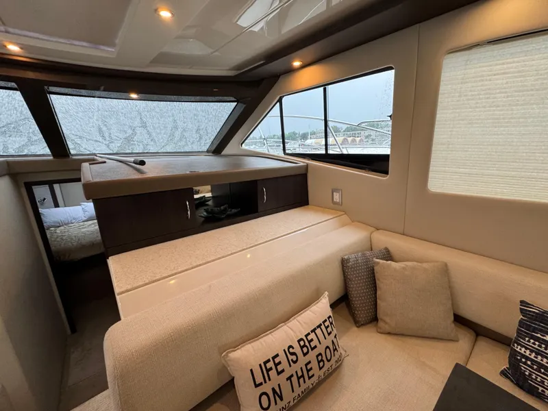 Slide: The Image of Interior of 2014 Carver C40 Command Bridge yacht with cozy seating and decorative pillows. - 34