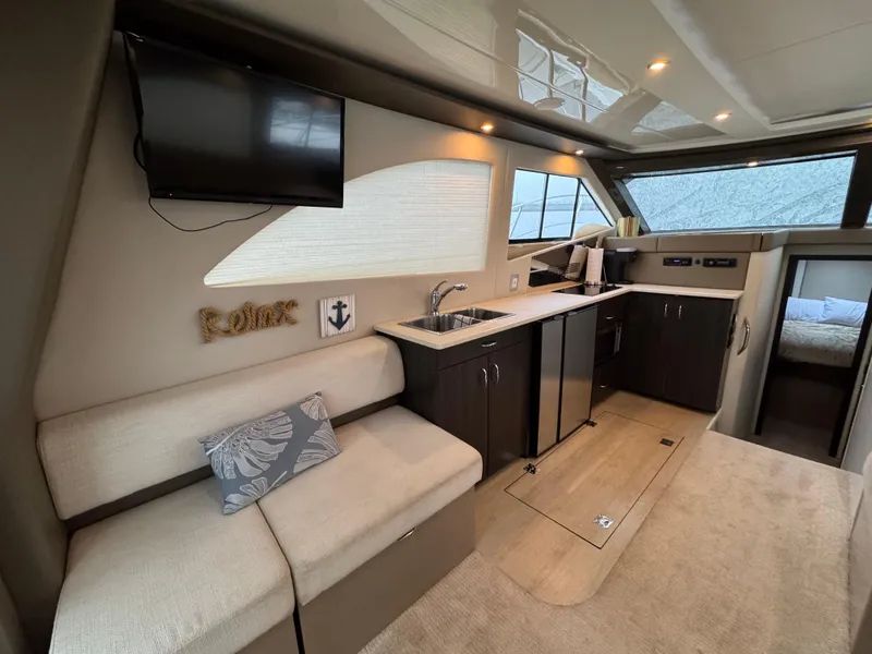 Slide: The Image of 2014 Carver C40 Command Bridge interior with modern kitchen and seating area. - 35