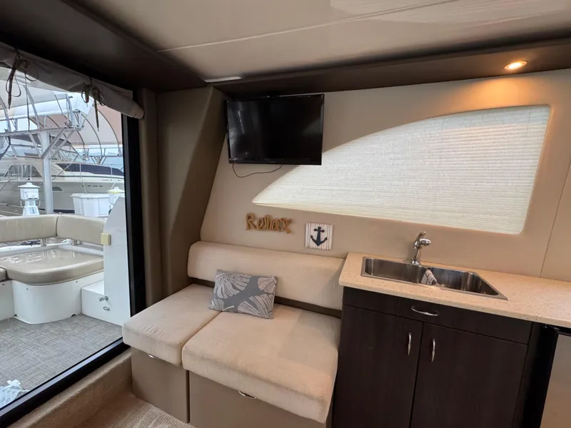 Slide: The Image of Interior of 2014 Carver C40 Command Bridge yacht with seating, sink, and TV. - 36