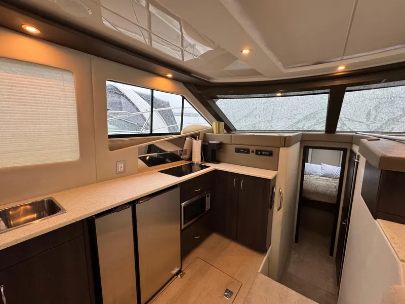 Slide: The Image of Interior of 2014 Carver C40 Command Bridge yacht, featuring modern kitchen and cozy cabin. - 38