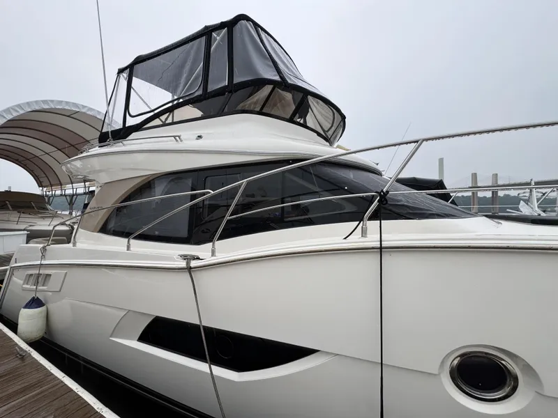 Slide: The Image of 2014 Carver C40 Command Bridge yacht docked at a marina. - 4