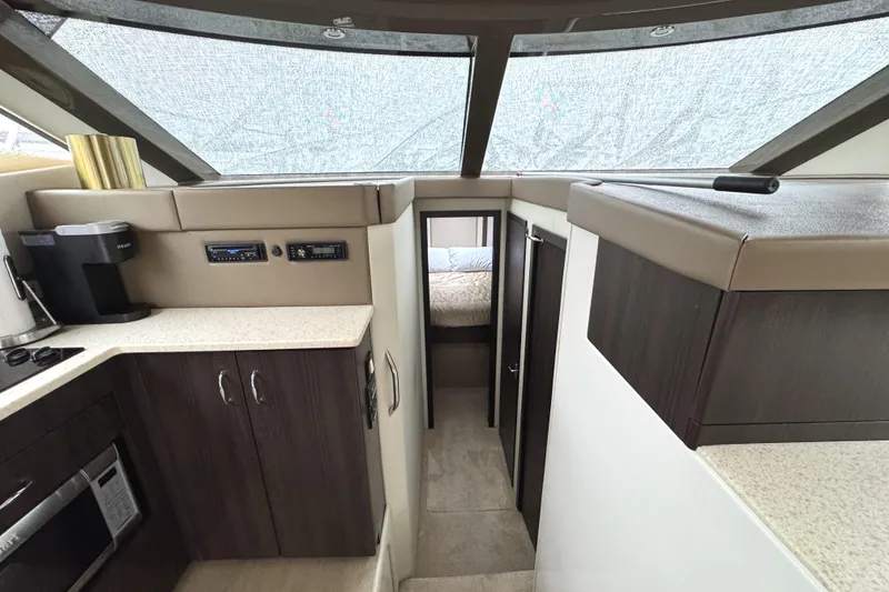 Slide: The Image of Interior of 2014 Carver C40 Command Bridge yacht with modern kitchen and cozy cabin. - 40