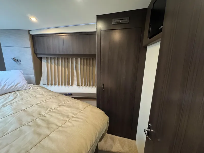 Slide: The Image of Bedroom interior of 2014 Carver C40 Command Bridge with wood paneling and cozy bedding. - 43