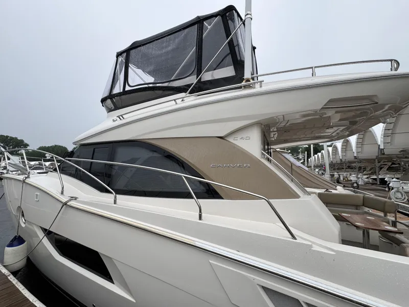 Slide: The Image of 2014 Carver C40 Command Bridge yacht docked at marina, side view. - 5