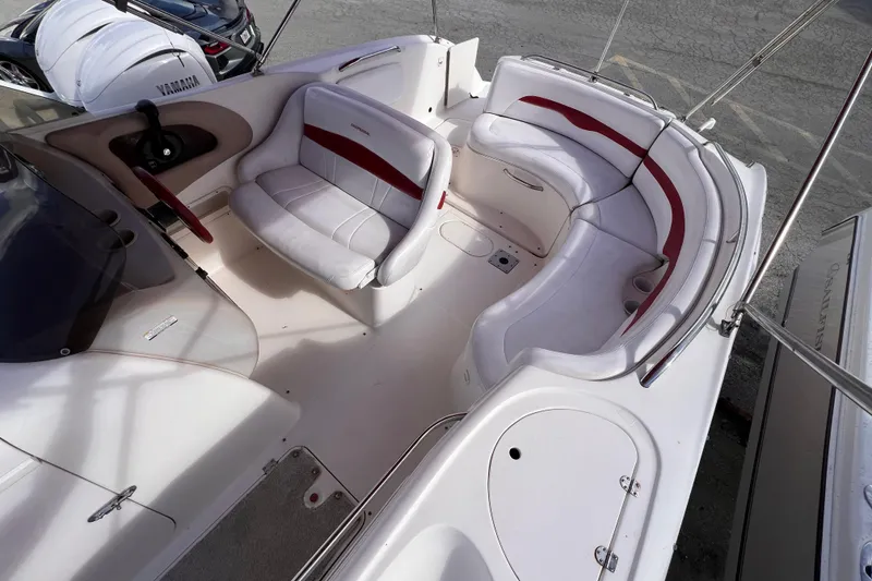 Slide: The Image of 2002 Chaparral 232 Sunesta boat interior with white and red seating arrangement. - 11