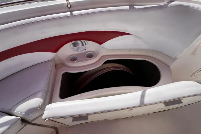 Slide: The Image of 2002 Chaparral 232 Sunesta boat interior with storage compartment and cup holders. - 14