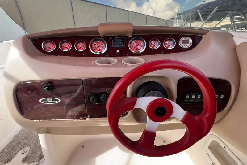Slide: The Image of 2002 Chaparral 232 Sunesta dashboard with red steering wheel and gauges. - 18