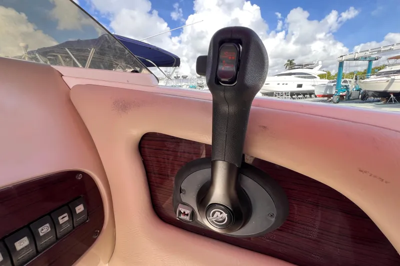 Slide: The Image of Throttle control of 2002 Chaparral 232 Sunesta boat, with marina view in background. - 19