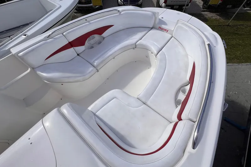 Slide: The Image of 2002 Chaparral 232 Sunesta boat interior with white and red seating. - 25