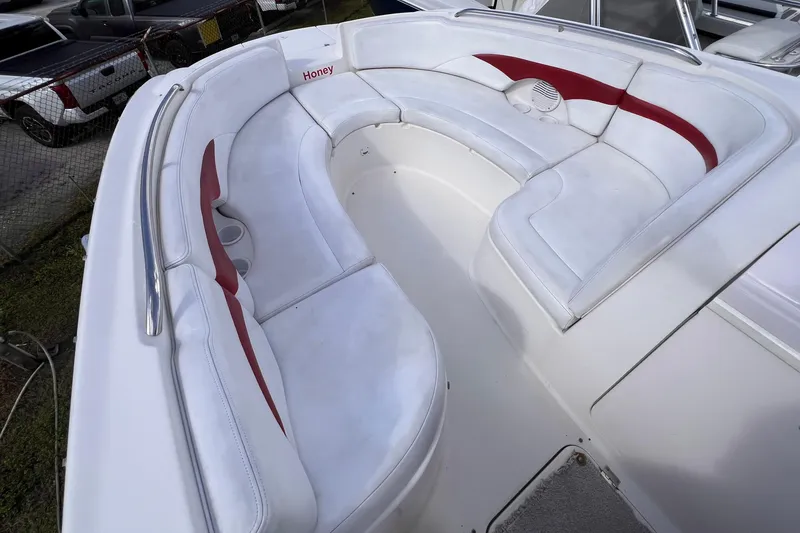 Slide: The Image of 2002 Chaparral 232 Sunesta boat interior with white and red cushioned seating. - 26