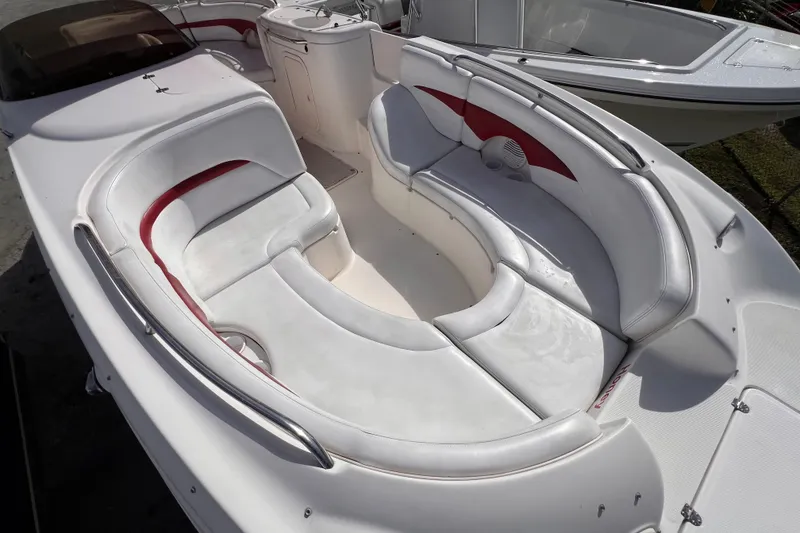 Slide: The Image of 2002 Chaparral 232 Sunesta boat with spacious white and red seating area. - 27