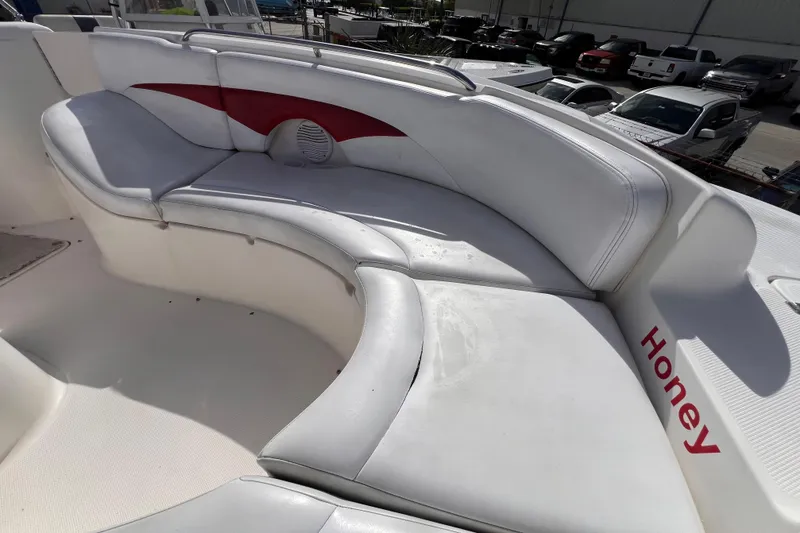 Slide: The Image of 2002 Chaparral 232 Sunesta boat with white and red seating, labeled "Honey." - 30