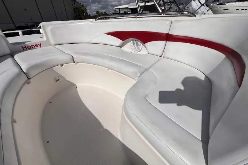 Slide: The Image of 2002 Chaparral 232 Sunesta boat interior with white and red seating. - 31