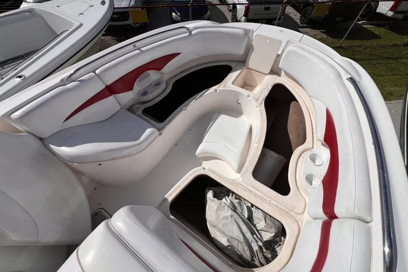 Slide: The Image of 2002 Chaparral 232 Sunesta boat interior with white and red seating, storage compartments. - 32