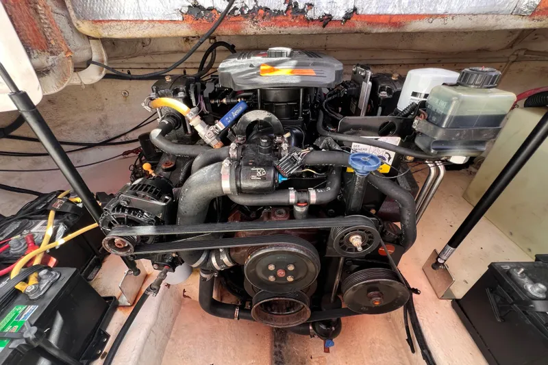 Slide: The Image of Engine compartment of a 2002 Chaparral 232 Sunesta boat, showcasing detailed components. - 35
