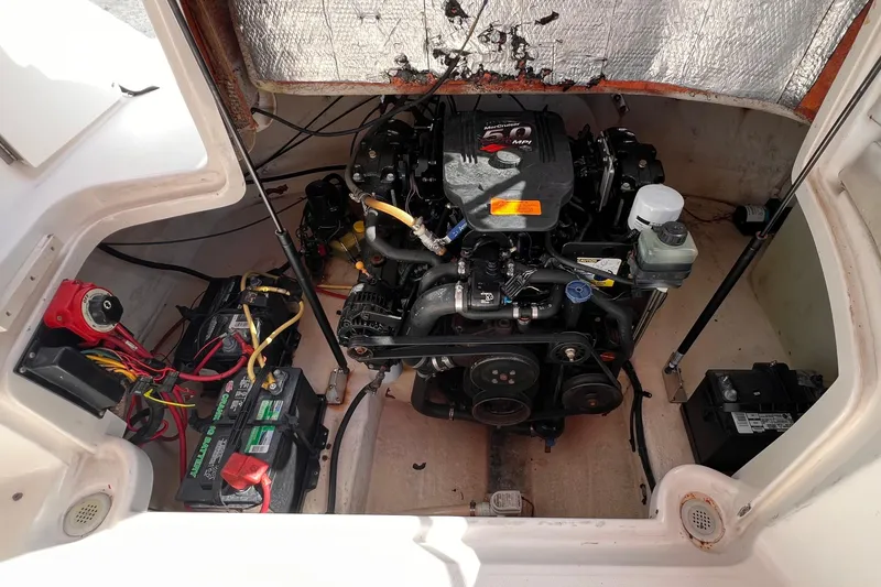 Slide: The Image of Engine compartment of a 2002 Chaparral 232 Sunesta boat, showing detailed components. - 37
