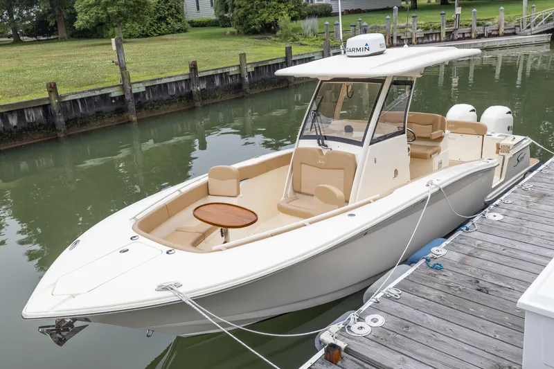 Slide: The Image of 2021 Scout 277LXF boat docked in a calm marina. - 1