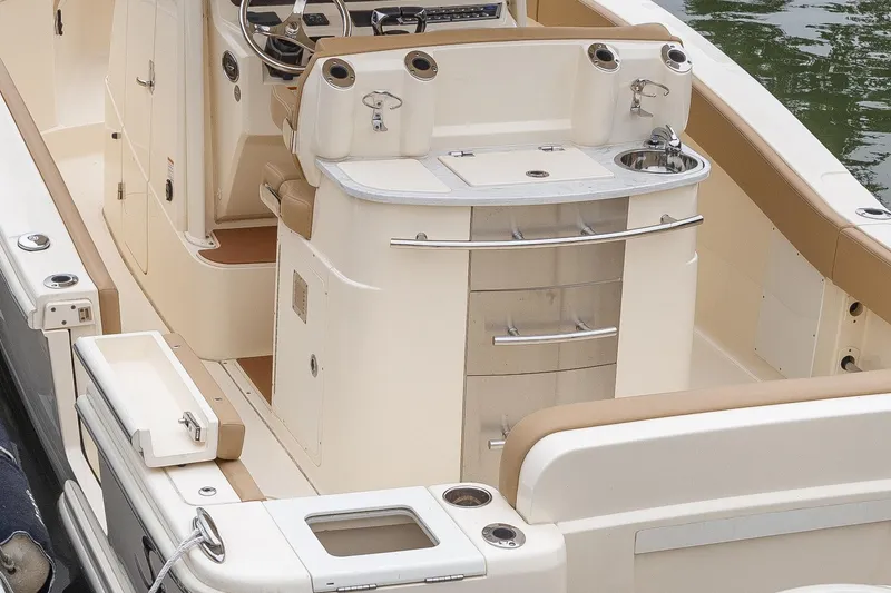 Slide: The Image of 2021 Scout 277LXF boat interior with helm station and seating. - 15