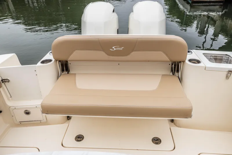 Slide: The Image of 2021 Scout 277LXF boat with tan fold-down bench seat and twin outboard motors. - 17