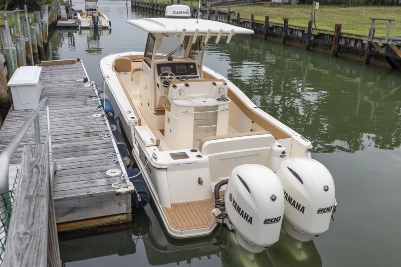 Slide: The Image of 2021 Scout 277LXF boat docked with twin Yamaha 200 engines. - 8
