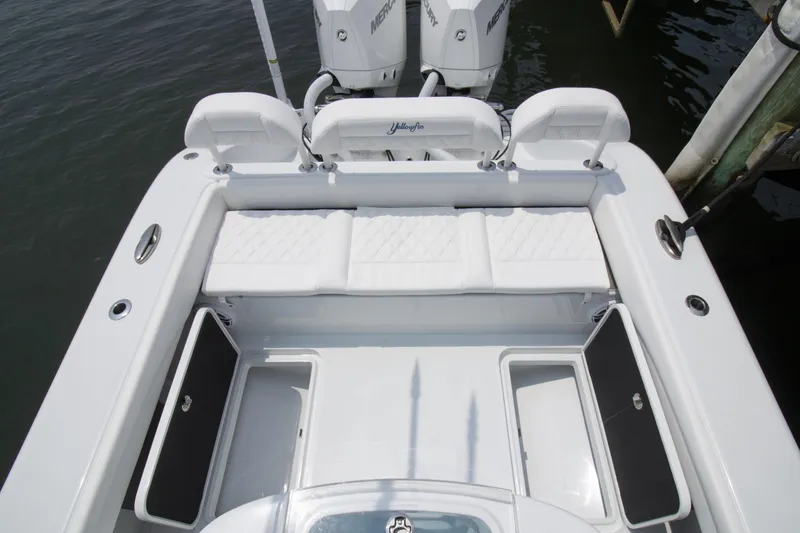 Slide: The Image of 2025 Yellowfin 26 Hybrid boat with white seating and storage compartments. - 10