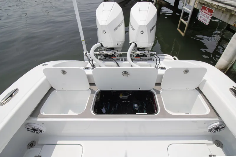 Slide: The Image of 2025 Yellowfin 26 Hybrid boat with dual Mercury engines and open storage compartments. - 11