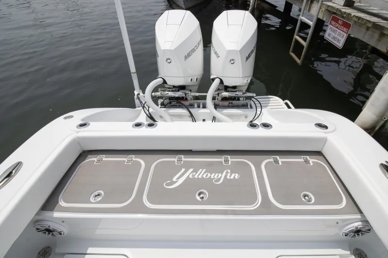 Slide: The Image of 2025 Yellowfin 26 Hybrid boat with dual Mercury engines at dock. - 12