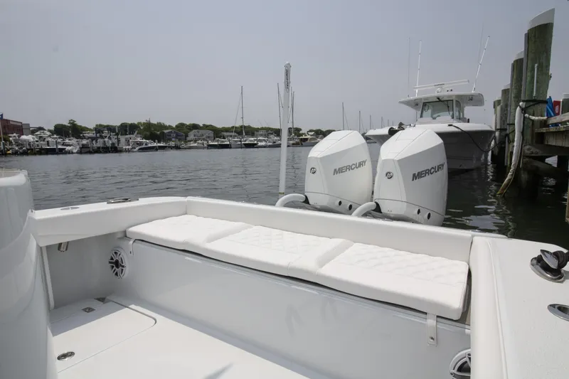 Slide: The Image of 2025 Yellowfin 26 Hybrid boat with twin Mercury engines docked at marina. - 14