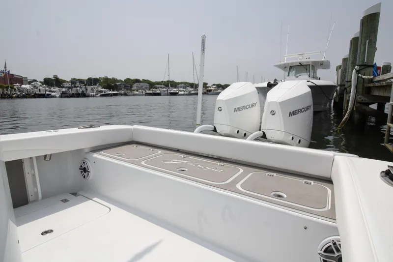 Slide: The Image of 2025 Yellowfin 26 Hybrid boat with dual Mercury engines docked at marina. - 15