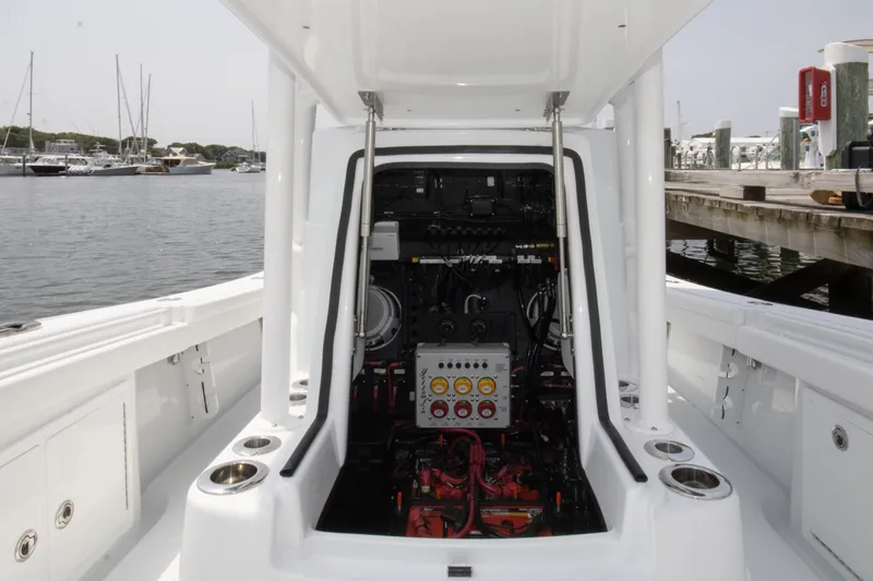 Slide: The Image of 2025 Yellowfin 26 Hybrid boat engine compartment at a marina dock. - 4