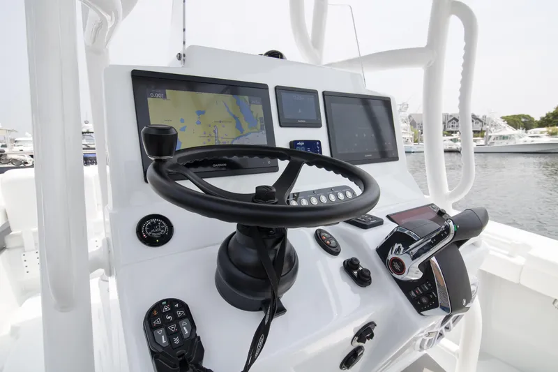 Slide: The Image of 2025 Yellowfin 26 Hybrid boat dashboard with navigation screens and steering wheel. - 6