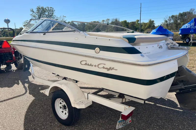 Slide: The Image of 1999 Chris-Craft 190 Bowrider boat on trailer, white with green accents. - 4